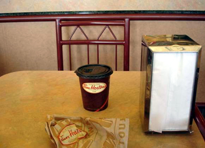 Tim Horton's coffee and unspecified confection in a paper bag