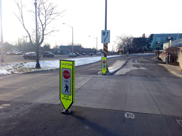 Pedestrian crossing at McMaster with sign warning drivers to yield to pedestrians