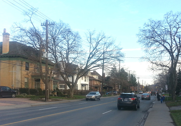 A mother walks her young children inches away from traffic lanes on Aberdeen Avenue