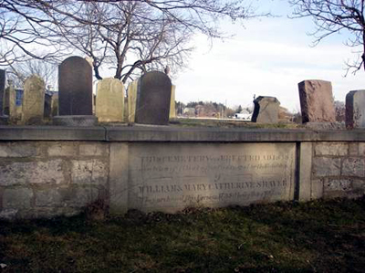 A small graveyard, sheltered in trees