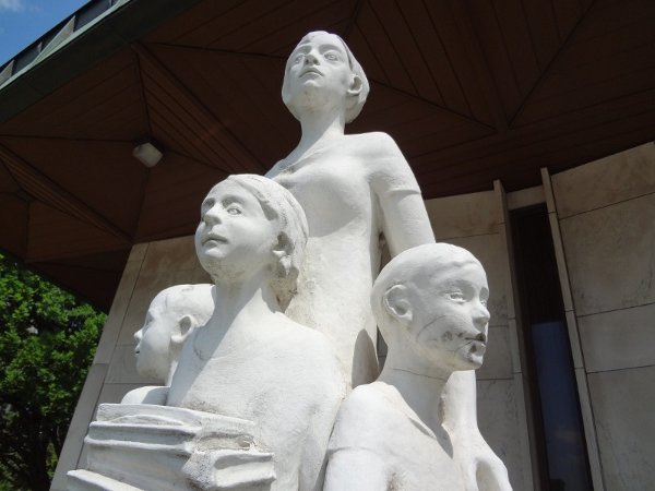 The statue of a teacher protecting her students in front of the Board of Education building is a grim irony (RTH file photo)