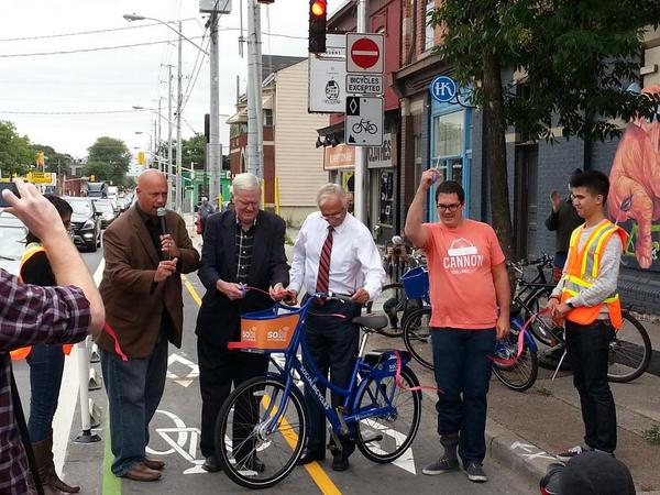 Councillor Jason Farr, Councillor Bob Morrow, Mayor Bob Bratina and Yes We Cannon coordinator Justin Jones cut the ribbon