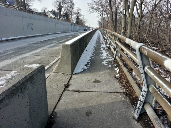 Opening in jersey barrier leading to stairs into Southam Park