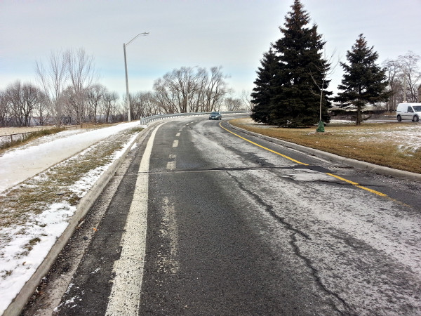 Two lanes merge into one lane before West 5th