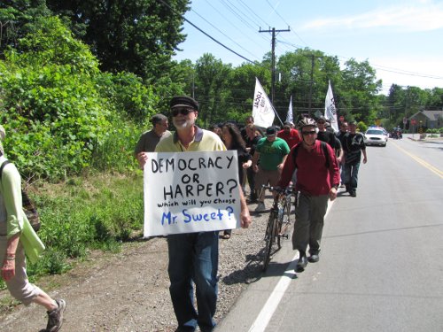 Protesters march to MP David Sweet's office