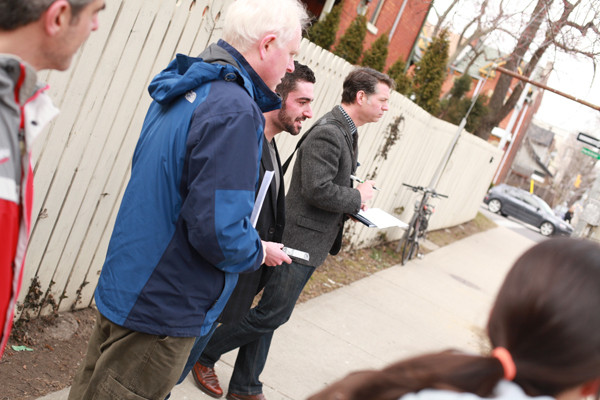 Ward 1 Councillor Brian McHattie observes traffic along Queen Street with study group participants.