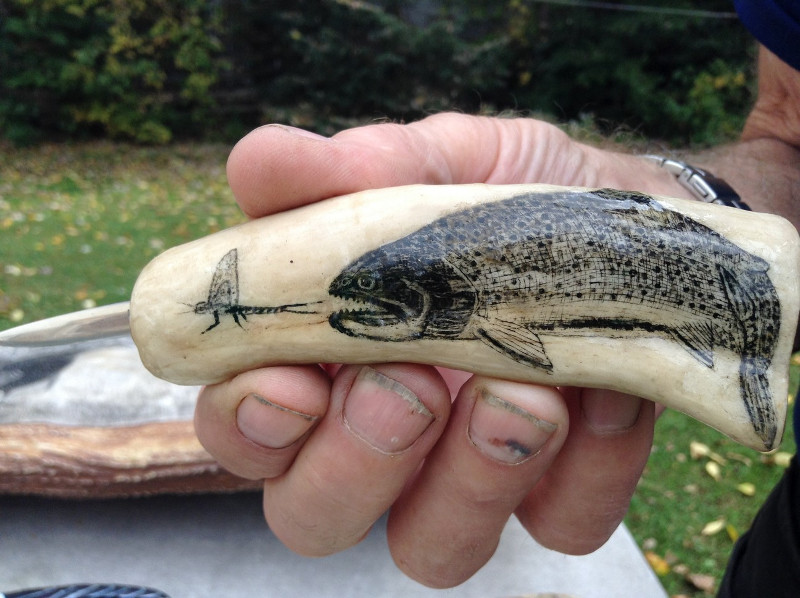 One of Dennis Sinclair's scrimshaw carving tools showing brook trout after a mayfly.