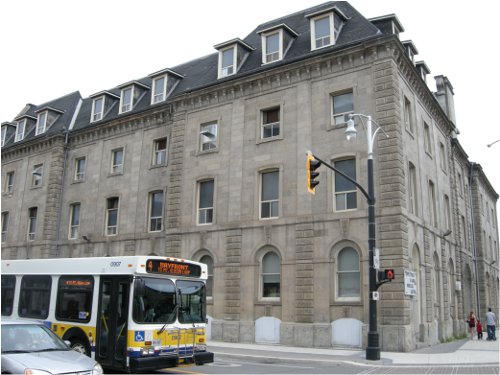 Very large non-landmark building across from Central Library. Rumoured to be associated with manufacturing of some sort.