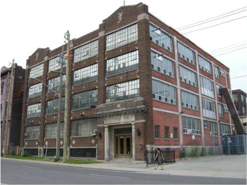 Insignificant building in downtown Hamilton. Also said to be associated with production of some sort. Note entirely forgettable ornamentation of ironwork, stained glass and brickwork at street level.