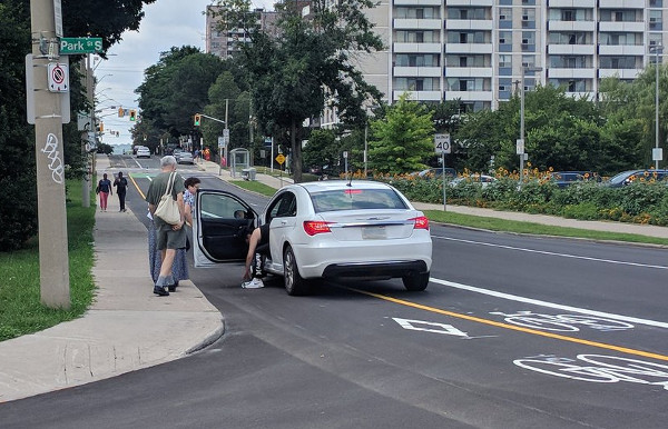 Car blocking the Hunter bike lanes at Park after driving over a knockdown stick