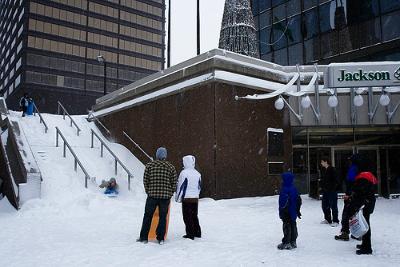 Children slide down the stairs from the Jackson Square Plaza at King and James (Image Credit: Flickr)