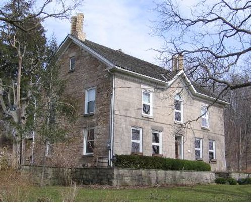 Figure 7: The Kelly House, on Old Dundas Road, was built in two parts: the lower story in 1845, and the upper part and façade in the late 1850s, after George Guest arrived from England. The stone work on the façade is near-ashlar. Note that the window sills (somewhat blackened) are Whirlpool sandstone.