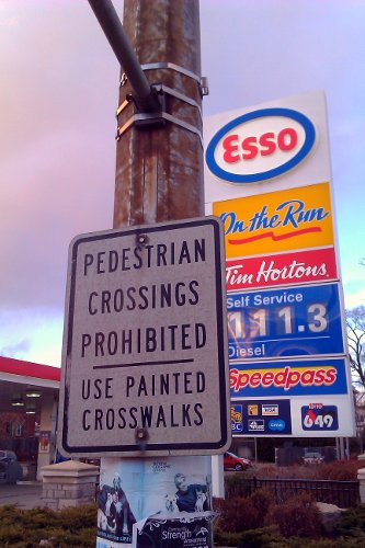 A sign on the northwest corner of King and Dundurn prohibits pedestrian crossings