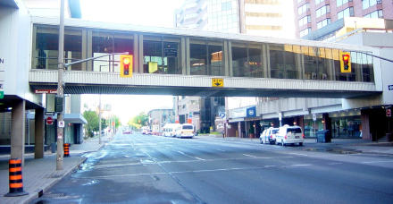 A failed idea in uban planning: this rusty, dishevelled pedestrian overpass has no business hovering over a downton street.