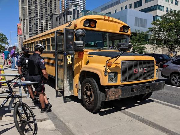 Police calmly negotiate with the 'hate bus' driver (Image Credit: Cameron Kroetsch)