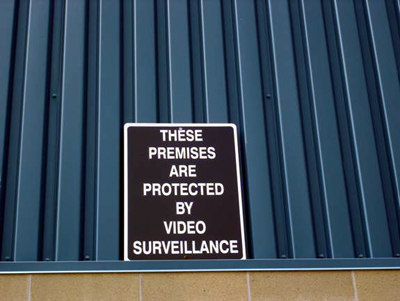 Sign: THESE PREMISES ARE PROTECTED BY VIDEO SURVEILLANCE