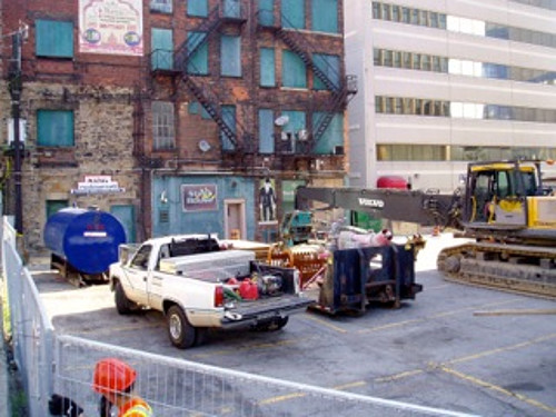 Fencing, a fuel tank and an excavator behind 18-28 King Street East (Image Credit: Eric McGuinness)