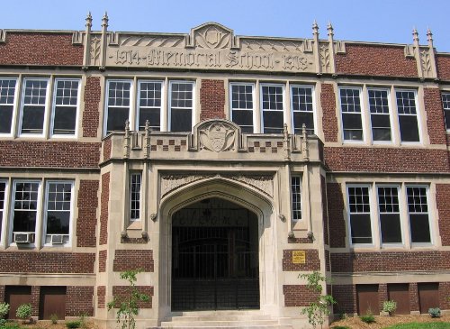Figure 12. Main door of Memorial Collegiate, built in 1919 of red brick and Indiana limestone. This was one of the first of a series of schools ornamented with elaborate carvings.