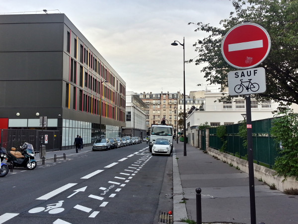 Contraflow bike lane with cars parked on the left side