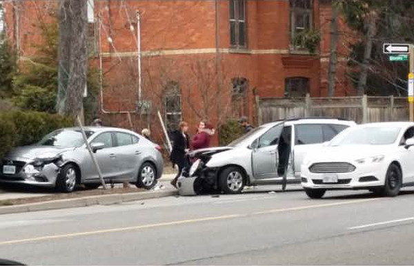 Car sitting across Queen Street sidewalk on march 28, 2018 (Image Credit: Tom Flood)