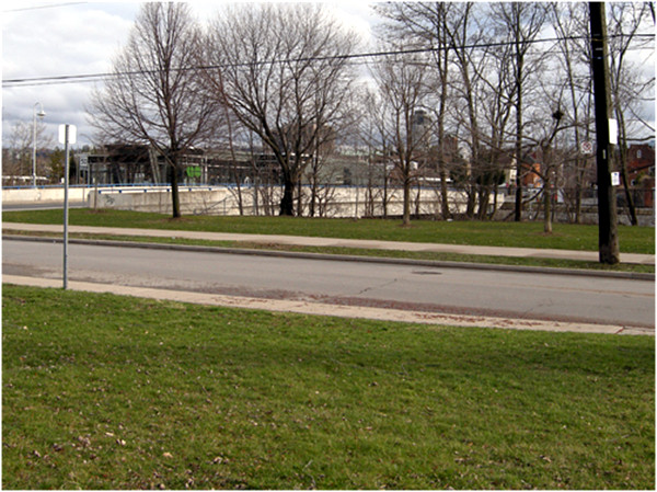 The West Harbour GO station from the Sunset Garden site. The application for an eleven storey building is posted on the lot at the south end of the MacNab Street bridge, at the left of the photo.