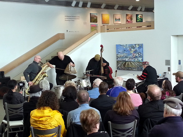 Sonoluminesence Trio: from left, David Mott on baritone saxaphone, Jesse Stewart on percussion and William Parker on Bass, plus artist in residence Jeff Schlanger painting the show