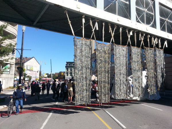 Art tapestries hung from the pedestrian overpass connecting the old Eaton's Parkade with City Centre