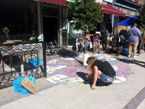 Artist Kiki LeFont painted a sidewalk mural outside Homegrown Hamilton on King William