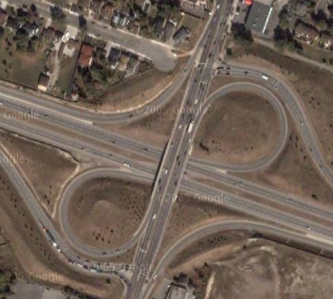 Cloverleaf interchange at the Lincoln Alexander Parkway and Upper James: Highways are voracious consumers of land, encircling huge parcels that serve no function whatsoever. (Image Credit: Google Maps)