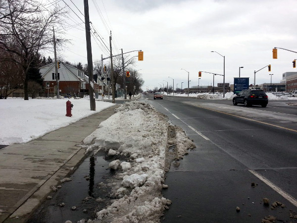 Northbound curb lane of West 5th piled with snow on March 3, 2016